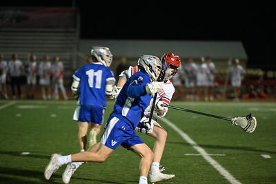 A cougar player runs past a defender with the ball