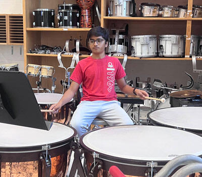 Student playing kettledrums