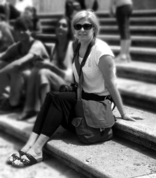 Woman with sunglasses sitting on some steps