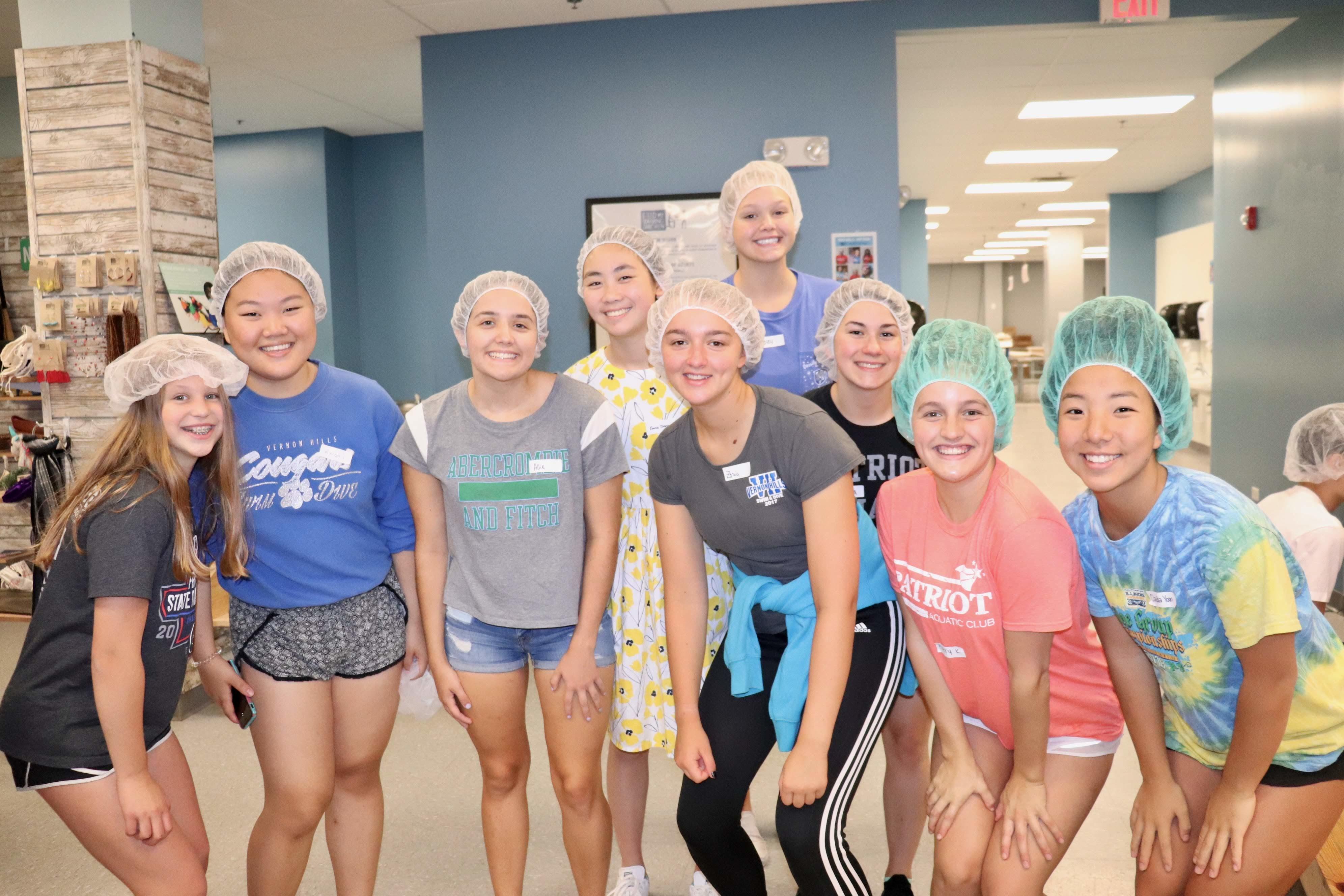 Swimmers Volunteering at Feed My Starving Children - Photo 2